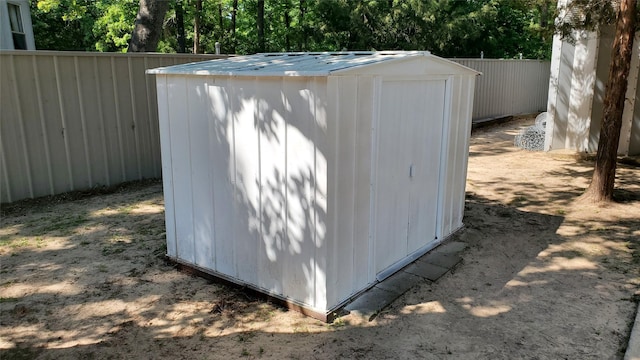 view of shed featuring fence