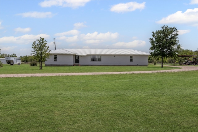 view of front of home with driveway, a front lawn, and metal roof