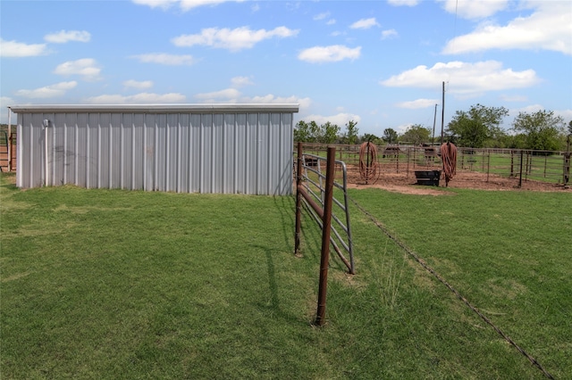 view of yard featuring fence, an outdoor structure, and an outbuilding