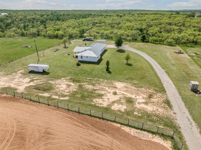 birds eye view of property featuring a view of trees and a rural view