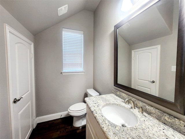 838 Milton Way, Coppell, TX 75019 - half bathroom featuring wood finished floors, lofted ceiling, baseboards, toilet, and vanity