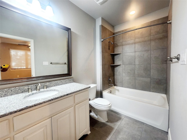 bathroom with toilet, vanity, tile patterned floors, and shower / tub combination