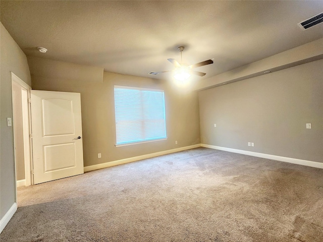 unfurnished room featuring baseboards, a ceiling fan, carpet flooring, and visible vents