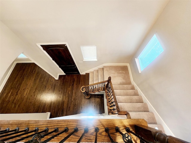 staircase featuring vaulted ceiling