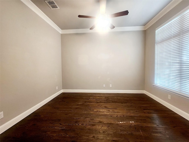 spare room with dark wood-style flooring, visible vents, ceiling fan, and crown molding