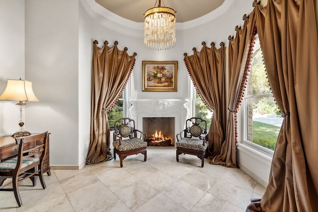 sitting room featuring baseboards, a notable chandelier, a high end fireplace, ornamental molding, and light tile patterned floors