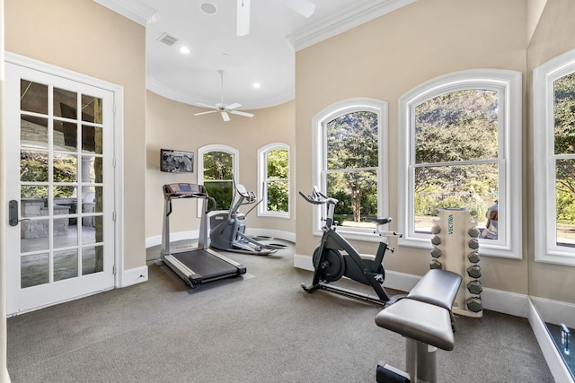 exercise room with ornamental molding, baseboards, and ceiling fan