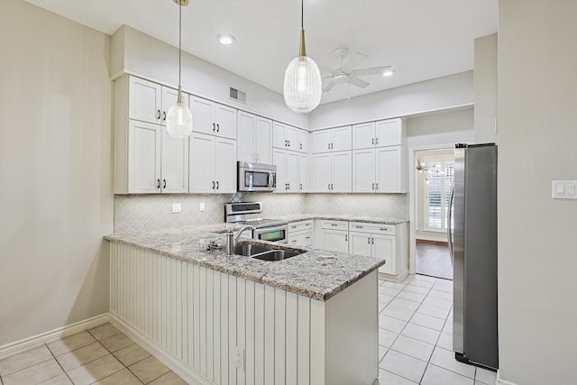 kitchen with a peninsula, visible vents, appliances with stainless steel finishes, ceiling fan, and light tile patterned floors
