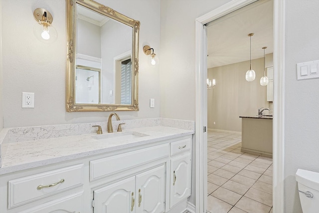 bathroom with tile patterned flooring, vanity, and toilet