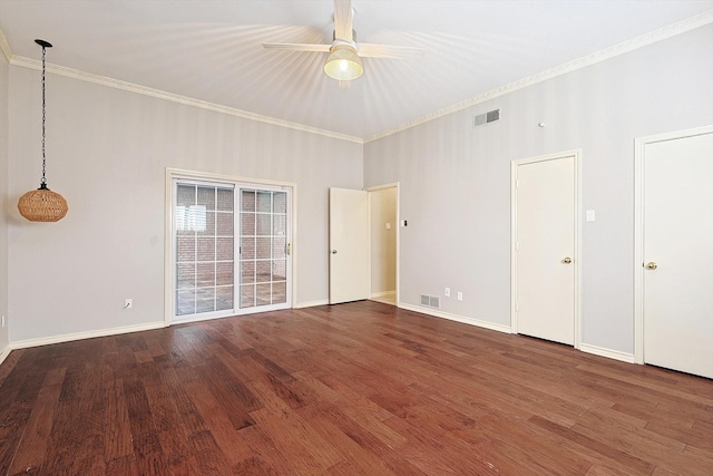 empty room with wood finished floors, visible vents, crown molding, baseboards, and ceiling fan