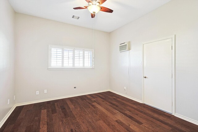 unfurnished room featuring a ceiling fan, visible vents, an AC wall unit, and dark wood-type flooring
