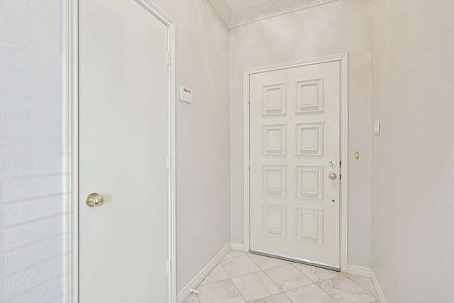 doorway to outside featuring baseboards and light tile patterned flooring