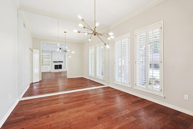 unfurnished dining area featuring baseboards, wood finished floors, a notable chandelier, and a healthy amount of sunlight
