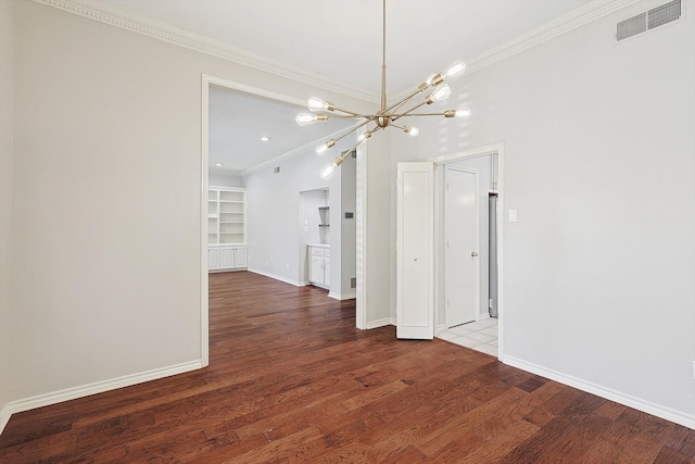 unfurnished dining area featuring wood finished floors, visible vents, a notable chandelier, and crown molding