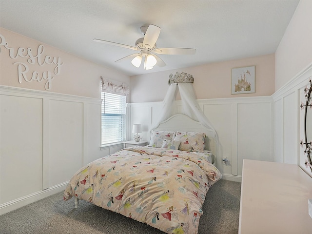 220 Glenwood Dr, Oak Point, TX 75068 - bedroom featuring carpet, ceiling fan, wainscoting, and a decorative wall