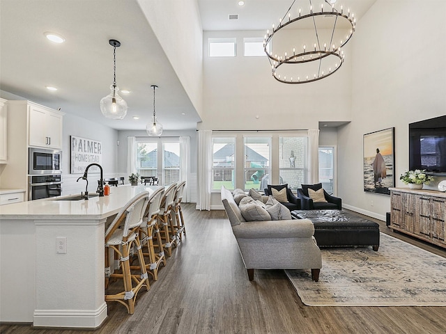 220 Glenwood Dr, Oak Point, TX 75068 - living room featuring dark wood-style flooring, a chandelier, recessed lighting, and baseboards