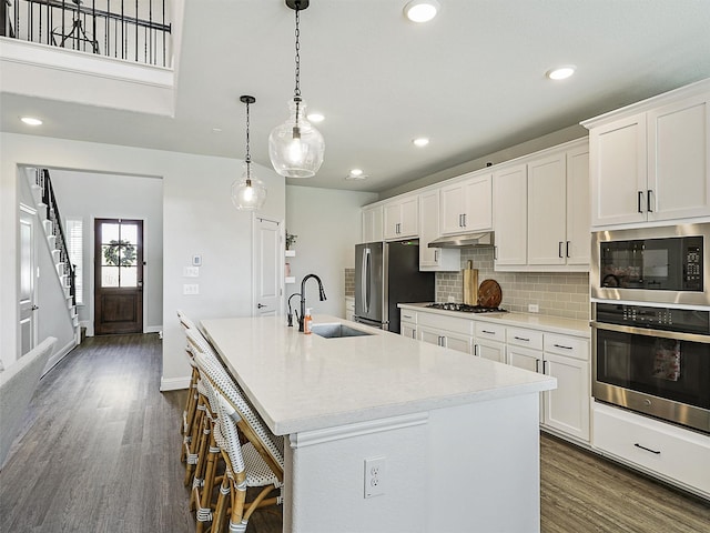 220 Glenwood Dr, Oak Point, TX 75068 - kitchen with a kitchen island with sink, dark wood-type flooring, stainless steel appliances, and a sink