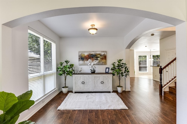 6807 Lagoon Dr, Grand Prairie, TX 75054 - entryway featuring arched walkways, dark wood-type flooring, healthy amount of natural light, and stairs