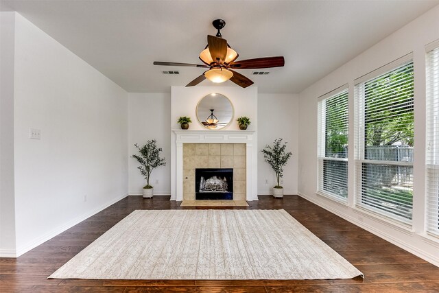 6807 Lagoon Dr, Grand Prairie, TX 75054 - unfurnished living room with dark wood-style floors, a tile fireplace, a ceiling fan, and baseboards