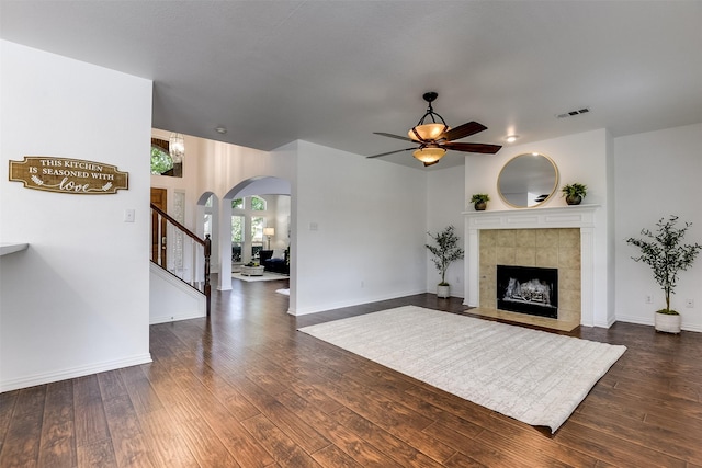 6807 Lagoon Dr, Grand Prairie, TX 75054 - living area with ceiling fan, arched walkways, dark wood finished floors, and stairs
