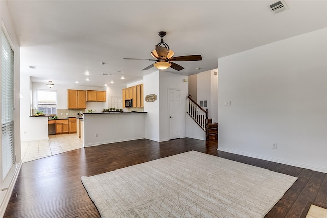 6807 Lagoon Dr, Grand Prairie, TX 75054 - unfurnished living room featuring light wood-type flooring, a ceiling fan, stairs, recessed lighting, and baseboards