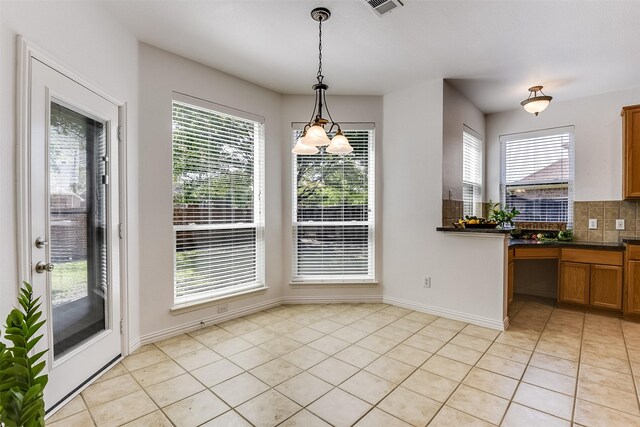 6807 Lagoon Dr, Grand Prairie, TX 75054 - unfurnished dining area featuring light tile patterned floors, plenty of natural light, and baseboards