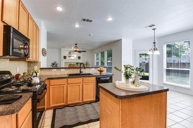 6807 Lagoon Dr, Grand Prairie, TX 75054 - kitchen featuring black appliances, a sink, light tile patterned flooring, a peninsula, and recessed lighting