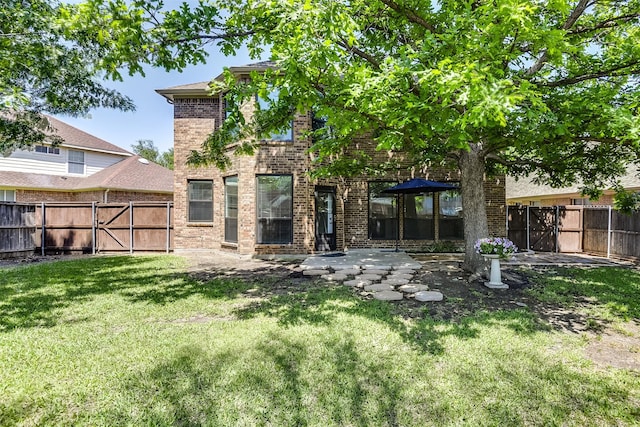 6807 Lagoon Dr, Grand Prairie, TX 75054 - back of property featuring brick siding, a patio area, and a gate