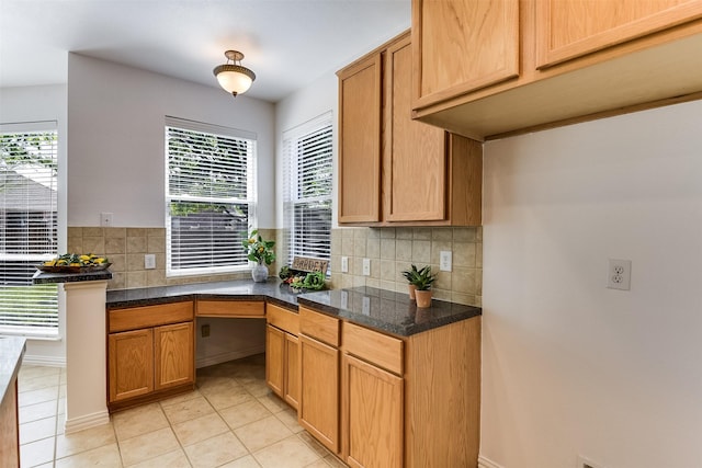 6807 Lagoon Dr, Grand Prairie, TX 75054 - kitchen with tasteful backsplash, dark countertops, and light tile patterned floors