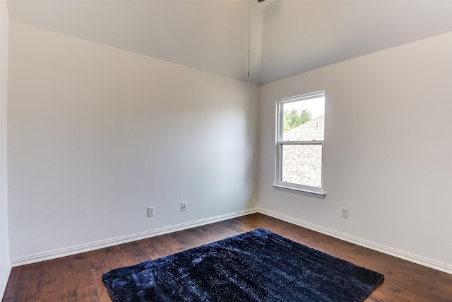 6807 Lagoon Dr, Grand Prairie, TX 75054 - spare room with baseboards, dark wood-style flooring, and lofted ceiling
