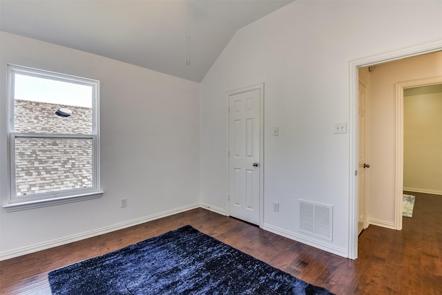 6807 Lagoon Dr, Grand Prairie, TX 75054 - empty room with wood finished floors, vaulted ceiling, and baseboards