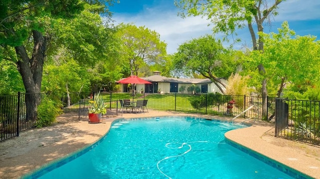 view of swimming pool featuring a fenced in pool, a patio area, and fence