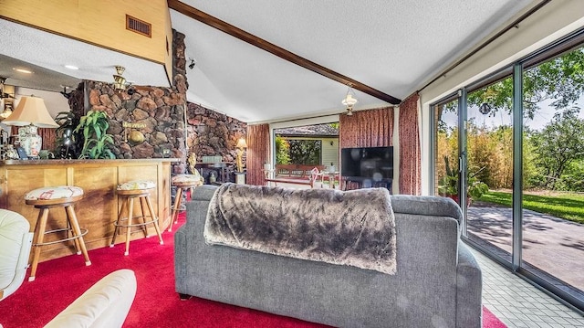 living area featuring a textured ceiling, vaulted ceiling with beams, carpet floors, a fireplace, and visible vents