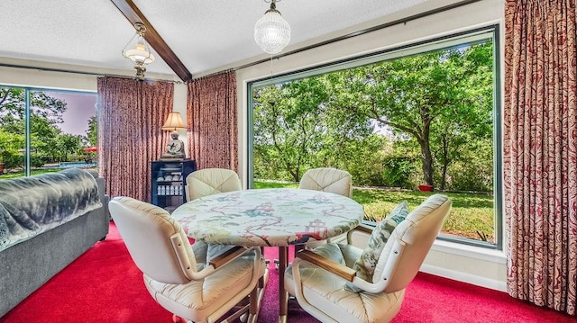 dining room featuring beamed ceiling, carpet floors, a textured ceiling, and baseboards