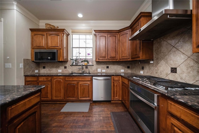 2905 White Dove Dr, Plano, TX 75093 - kitchen featuring stainless steel appliances, wall chimney range hood, dark wood finished floors, crown molding, and tasteful backsplash