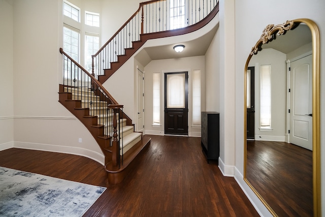 2905 White Dove Dr, Plano, TX 75093 - foyer with dark wood finished floors, stairway, a towering ceiling, and arched walkways