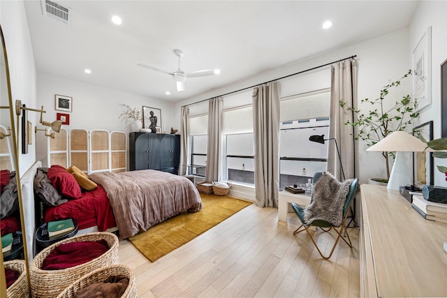 bedroom with recessed lighting, wood finished floors, visible vents, and a ceiling fan