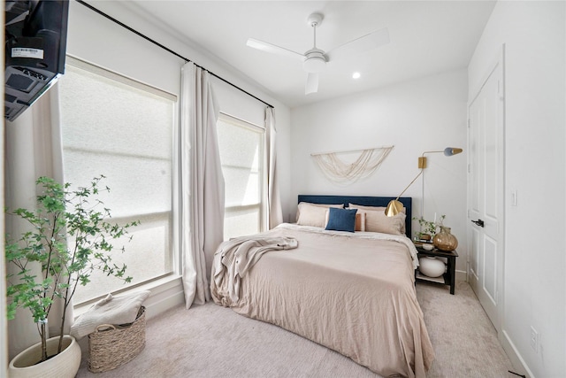 bedroom with light carpet, a ceiling fan, baseboards, and recessed lighting