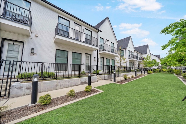 surrounding community with fence, a yard, and a residential view