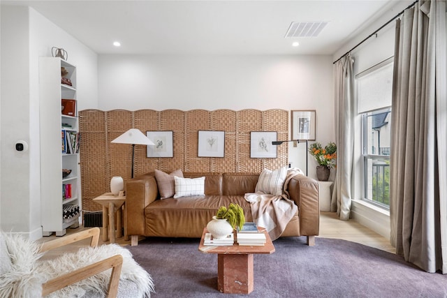 living area with recessed lighting, carpet floors, and visible vents