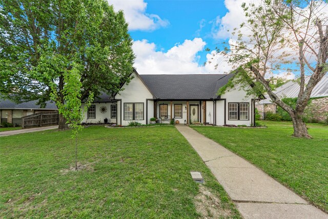 view of front of house featuring roof with shingles and a front lawn