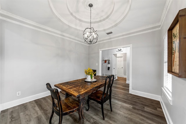 dining area featuring dark wood-type flooring, ornamental molding, baseboards, and a notable chandelier