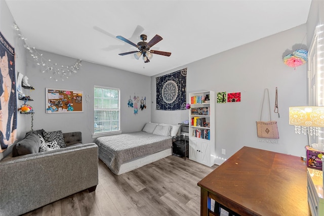 bedroom featuring wood finished floors and ceiling fan