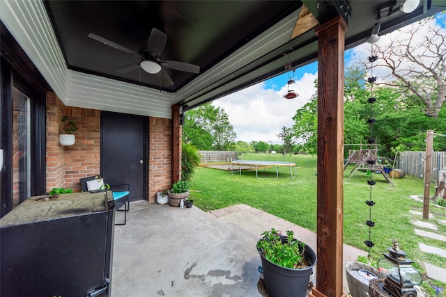 view of patio featuring a fenced backyard, a playground, a ceiling fan, and a trampoline
