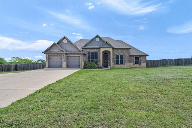 view of front facade featuring a front lawn, driveway, fence, brick siding, and an attached garage