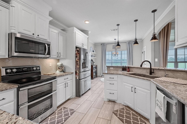 kitchen featuring tasteful backsplash, plenty of natural light, appliances with stainless steel finishes, and a sink