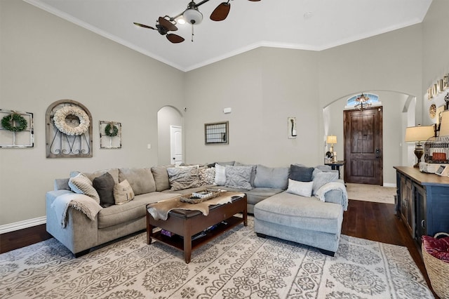 living area with high vaulted ceiling, ceiling fan, arched walkways, and wood finished floors