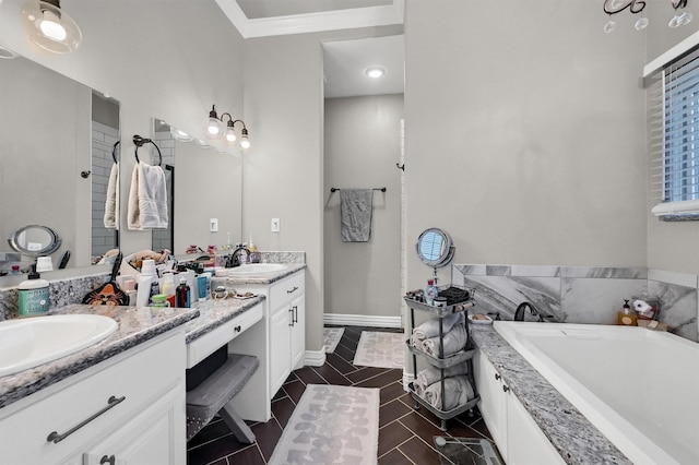 full bathroom featuring tile patterned floors, a bathtub, baseboards, vanity, and ornamental molding