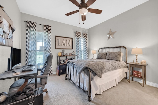 bedroom featuring light carpet, baseboards, and ceiling fan
