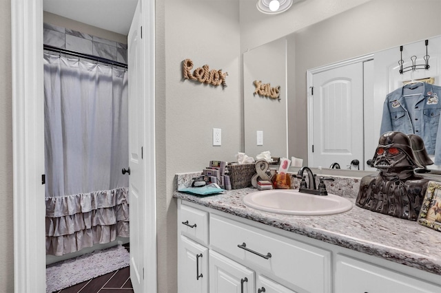 bathroom with vanity and curtained shower